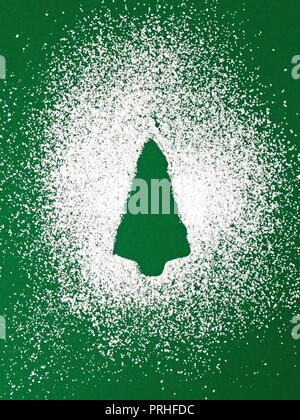 Christmas tree from sugar powder on green background Stock Photo