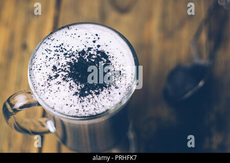 BLACK GOTH/GOTHIC CHARCOAL LATTE. Autumn Halloween coffee drink. Close up Stock Photo