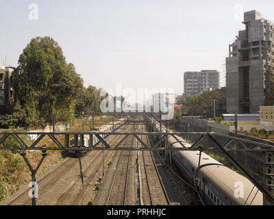 VIEW OF RAILWAY TRACKS AND LOCAL TRAINS IN MUMBAI, INDIA, ASIA Stock Photo