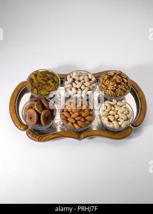 Dryfruits and nuts in six bowls shot against a white background Stock Photo