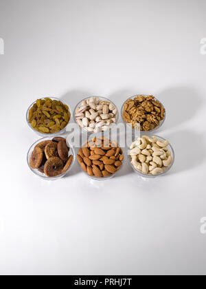 Dryfruits and nuts in six bowls shot against a white background Stock Photo