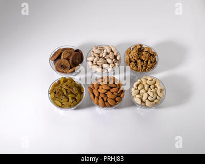 Dryfruits and nuts in six bowls shot against a white background Stock Photo