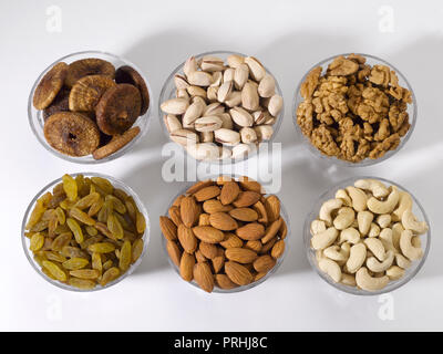 Dryfruits and nuts in six bowls shot against a white background Stock Photo
