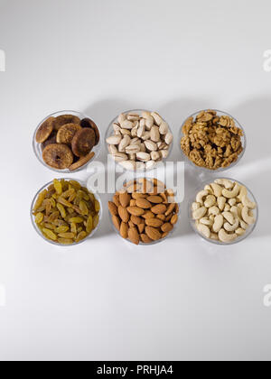 Dryfruits and nuts in six bowls shot against a white background Stock Photo