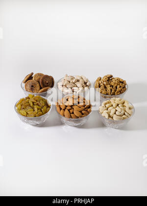 Dryfruits and nuts in six bowls shot against a white background Stock Photo