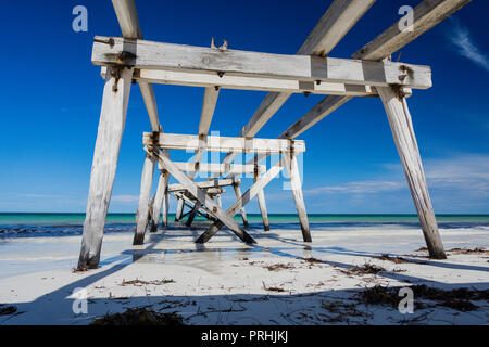 The ruins of the old historic wooden jetty on the coastline at Eucla Western Australia Stock Photo