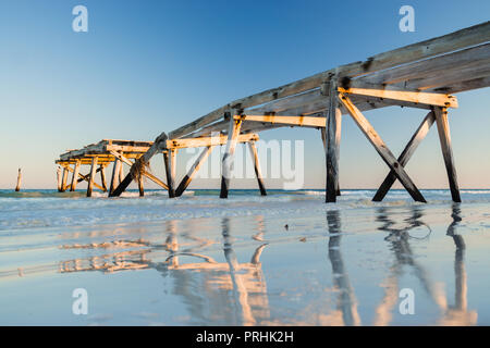 The ruins of the old historic wooden jetty on the coastline at Eucla Western Australia Stock Photo