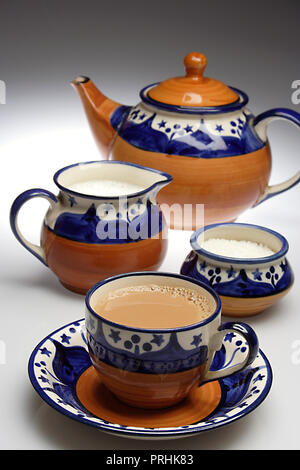 Masala Tea Chai hot in an ethnic tea set on a white background Stock Photo