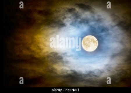 Full vector moon over dark cloudy midnight sky. Spooky moonlight Halloween background Stock Vector