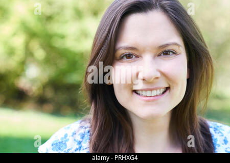 Outdoor Head And Shoulders Portrait Of Laughing Young Woman Stock Photo