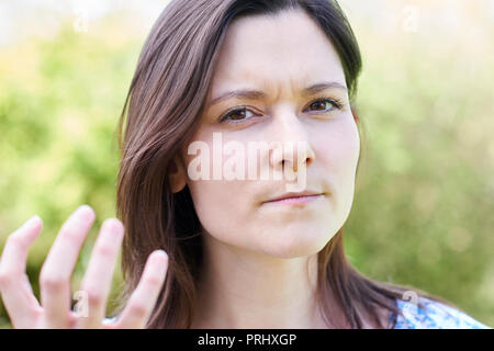 Outdoor Portrait Of Frustrated Young Woman Stock Photo