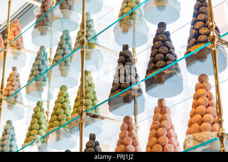 Pyramids of colorful macarons on display Stock Photo