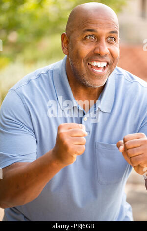 Excited African American man pumping his fist. Stock Photo
