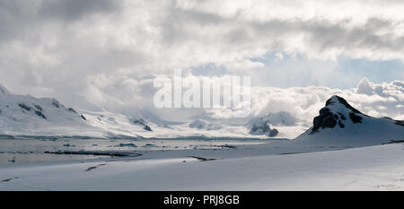 Billowing clouds over snow-covered mountains and icebergs, Livingstone Island, Antarctic Peninsula Stock Photo