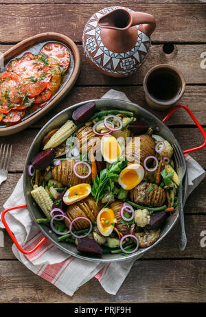 Baked root vegetables in a pan, rustic style Stock Photo