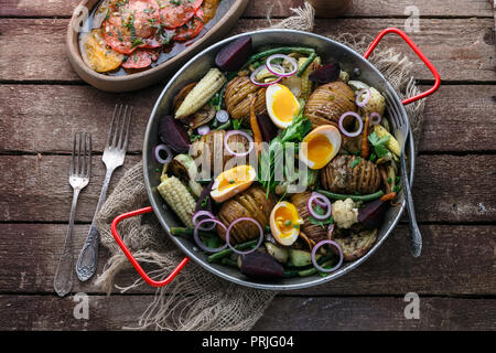 Baked potatoes, carrots, green beans and eggs. Stock Photo