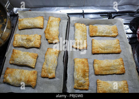 Freshly baked puff pastry on a baking tray Stock Photo