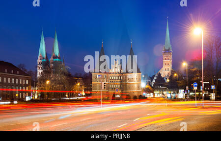 St. Mary's Church, Holsten Gate and St. Peter's Church, street with traces of light, night view, Lübeck, Schleswig-Holstein Stock Photo