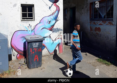 Children play football in Khayelitsha Township, Cape Town, Western Cape, South Africa Stock Photo