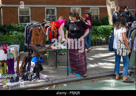Shoppers search for bargains at the humongous Penn South Flea Market in the New York neighborhood of Chelsea on Saturday, September 22, 2018. The flea market appears like Brigadoon, only once every year, and the residents of the 20 building Penn South cooperatives have a closet cleaning extravaganza. Shoppers from around the city come to the flea market which attracts thousands passing through.  (Â© Richard B. Levine) Stock Photo