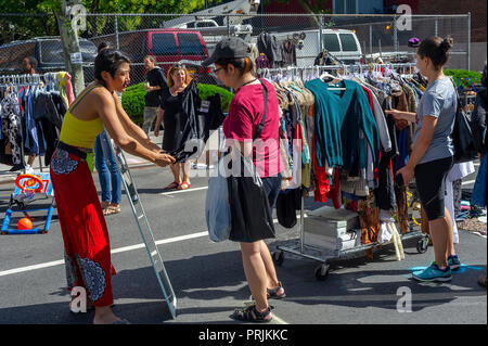 Shoppers search for bargains at the humongous Penn South Flea Market in the New York neighborhood of Chelsea on Saturday, September 22, 2018. The flea market appears like Brigadoon, only once every year, and the residents of the 20 building Penn South cooperatives have a closet cleaning extravaganza. Shoppers from around the city come to the flea market which attracts thousands passing through.  (© Richard B. Levine) Stock Photo