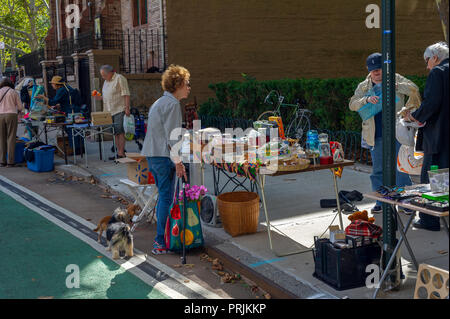 Shoppers search for bargains at the humongous Penn South Flea Market in the New York neighborhood of Chelsea on Saturday, September 22, 2018. The flea market appears like Brigadoon, only once every year, and the residents of the 20 building Penn South cooperatives have a closet cleaning extravaganza. Shoppers from around the city come to the flea market which attracts thousands passing through.  (Â© Richard B. Levine) Stock Photo
