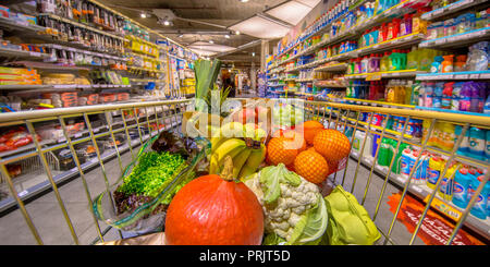 Healthy Fruit and vegetables in Grocery shop cart in supermarket filled with food products as seen from the customers point of view Stock Photo