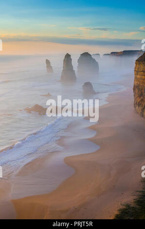 The 12 Apostles shrouded in fog, Port Campbell National Park, Shipwreck Coast, Great Ocean Road, Victoria, Australia Stock Photo