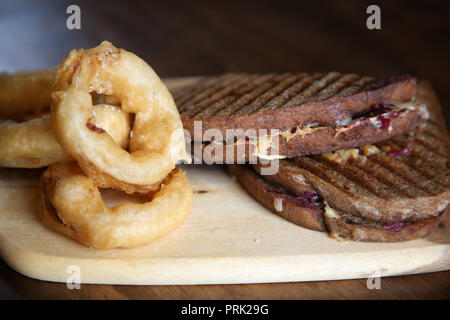 Pictured: Sandwich or toastie and onion rings at Jack & Knife restaurant at 76 Stanley St, Darlinghurst, Sydney, Australia. Stock Photo