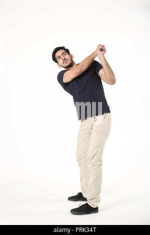 Portrait of young boy playing with golf stick. Isolated on white background. Stock Photo