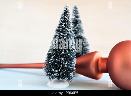 winter holiday decor with small christmas trees and copper colored peak ornament Stock Photo