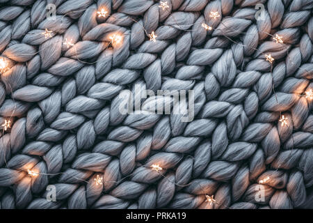 Christmas lights on warm woolen sweater,Closeup Stock Photo