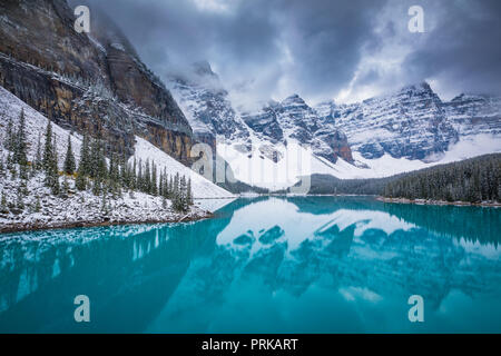 Moraine Lake is a glacially fed lake in Banff National Park, 14 kilometres (8.7 mi) outside the Village of Lake Louise, Alberta, Canada. Stock Photo