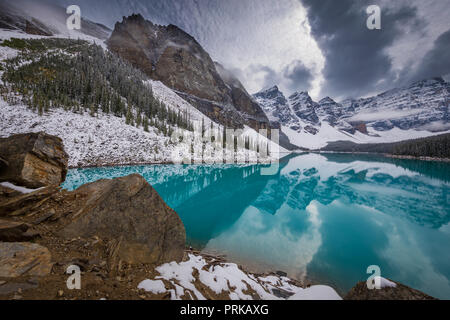 Moraine Lake is a glacially fed lake in Banff National Park, 14 kilometres (8.7 mi) outside the Village of Lake Louise, Alberta, Canada. Stock Photo