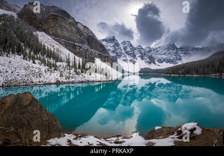 Moraine Lake is a glacially fed lake in Banff National Park, 14 kilometres (8.7 mi) outside the Village of Lake Louise, Alberta, Canada. Stock Photo