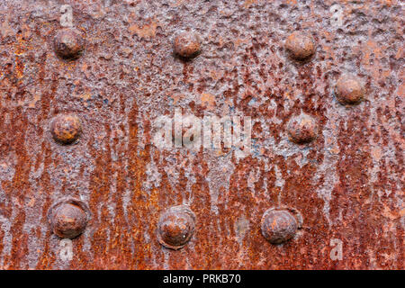 Backgrounds and textures: rusty metal wall surface with riveted joints, industrial abstract Stock Photo