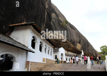 People, pilgrims, and tourists around the Dambulla Cave Temple. Taken in Srilanka, August 2018. Stock Photo