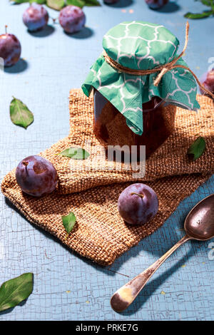 Homemade plum jam with plum fruit  on blue old table Stock Photo