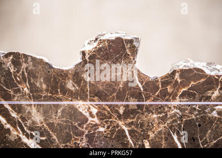 broken marble in the dark and warm colors, marble background texture, closeup Stock Photo