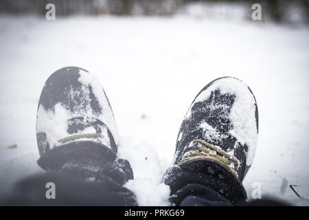 mens boots in the snow, winter concept Stock Photo