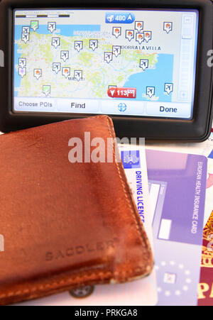 Satnav for Spain with EU United Kingdom of Great Britain and Northern Ireland biometric passport with Euro cash notes, EHIC card, driving licence Stock Photo