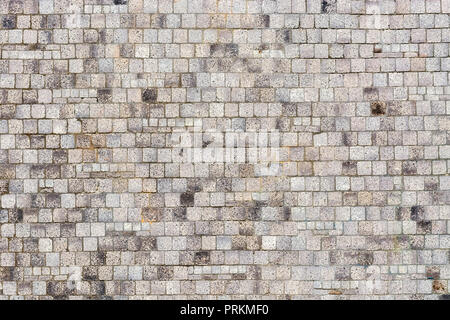A fragment of a wall, lined with gray tiles, for use as a background. Stock Photo