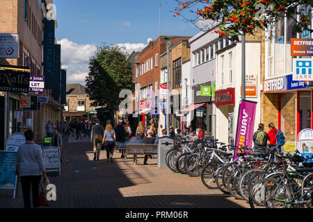 View of the pedestrianised Burleigh Street with people walking past shops on a sunny Summer day, Cambridge, UK Stock Photo