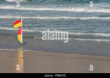 Bathing Flags – only swim between two Yellow and Orange flags. Seaside, beach safety warning flags. Stock Photo