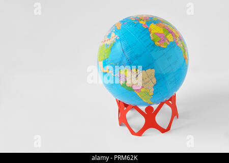 Paper people in a circle holding earth globe - Save the world concept Stock Photo