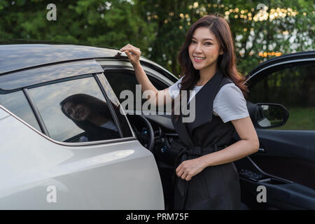 beautiful woman standing and open the car door Stock Photo