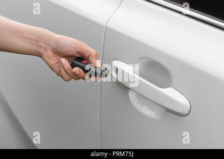 hand using remote key to unlocked a car Stock Photo