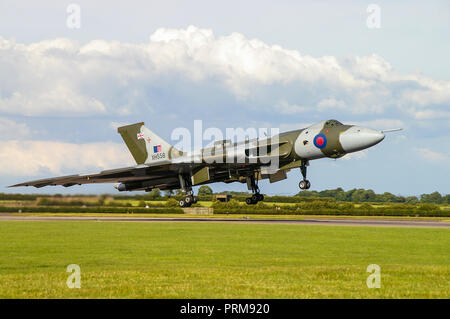 Avro Vulcan B2 jet plane XH558. Former RAF, Royal Air Force Cold War nuclear bomber landing at RAF Waddington for an airshow. Restored Stock Photo