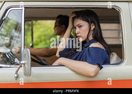 stressed woman sitting inside a vintage car Stock Photo