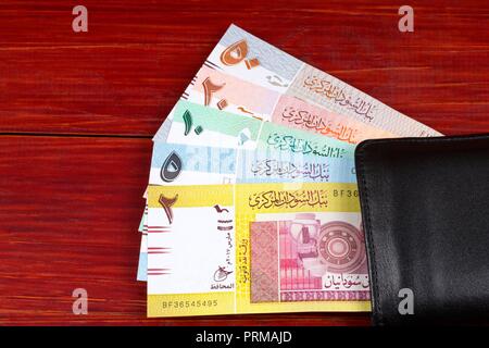 Money from Sudan in the black wallet Stock Photo